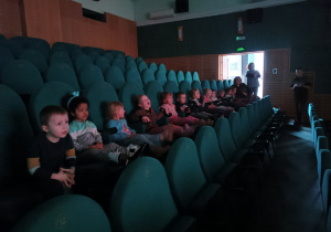 Zwiedzanie dużej sali kinowej. Dzieci zasiadają na widowni.