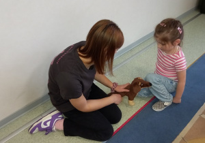 Tosia uczy się jak głaska pieska.