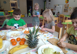 dzieci kroją owoce