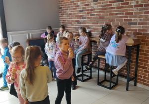 Dzieci jedzą lody w cukierni