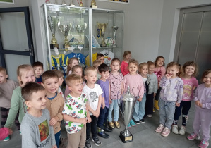 Dzieci oglądają puchary drużyny piłkarskiej